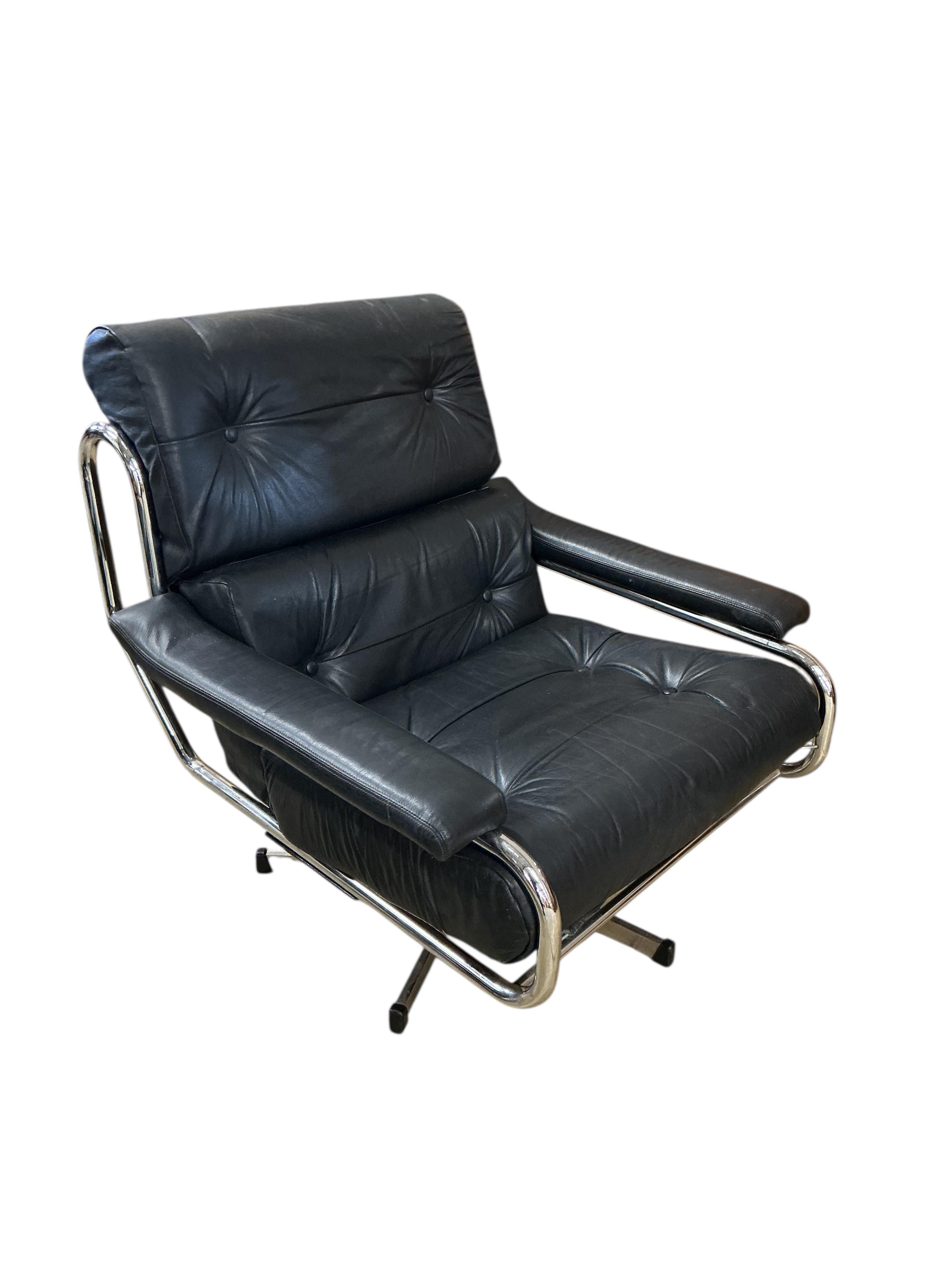 A near pair of mid century Pieff black and green leather swivel lounge chairs on chrome five prong bases, width 86cm, depth 94cm, height 91cm, one with a footstool
